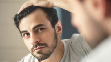 close up of handsome man looking in mirror at home royalty free image 1621275569